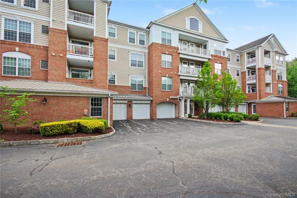 a front view of a multi story residential apartment building with a yard