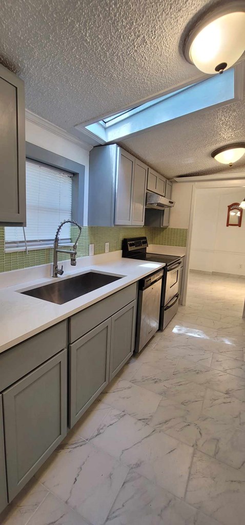 125 Sputnik Street Fortson, GA 31808 - Photo 5 of 30 a kitchen with a sink and cabinets