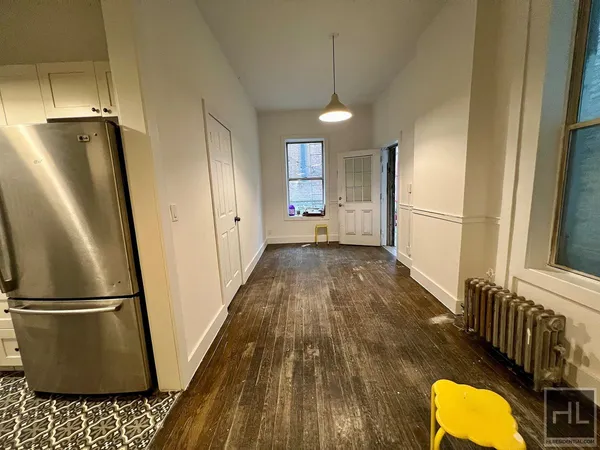 a view of a refrigerator in kitchen and wooden floor