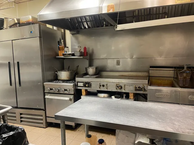 a kitchen with refrigerator and stove