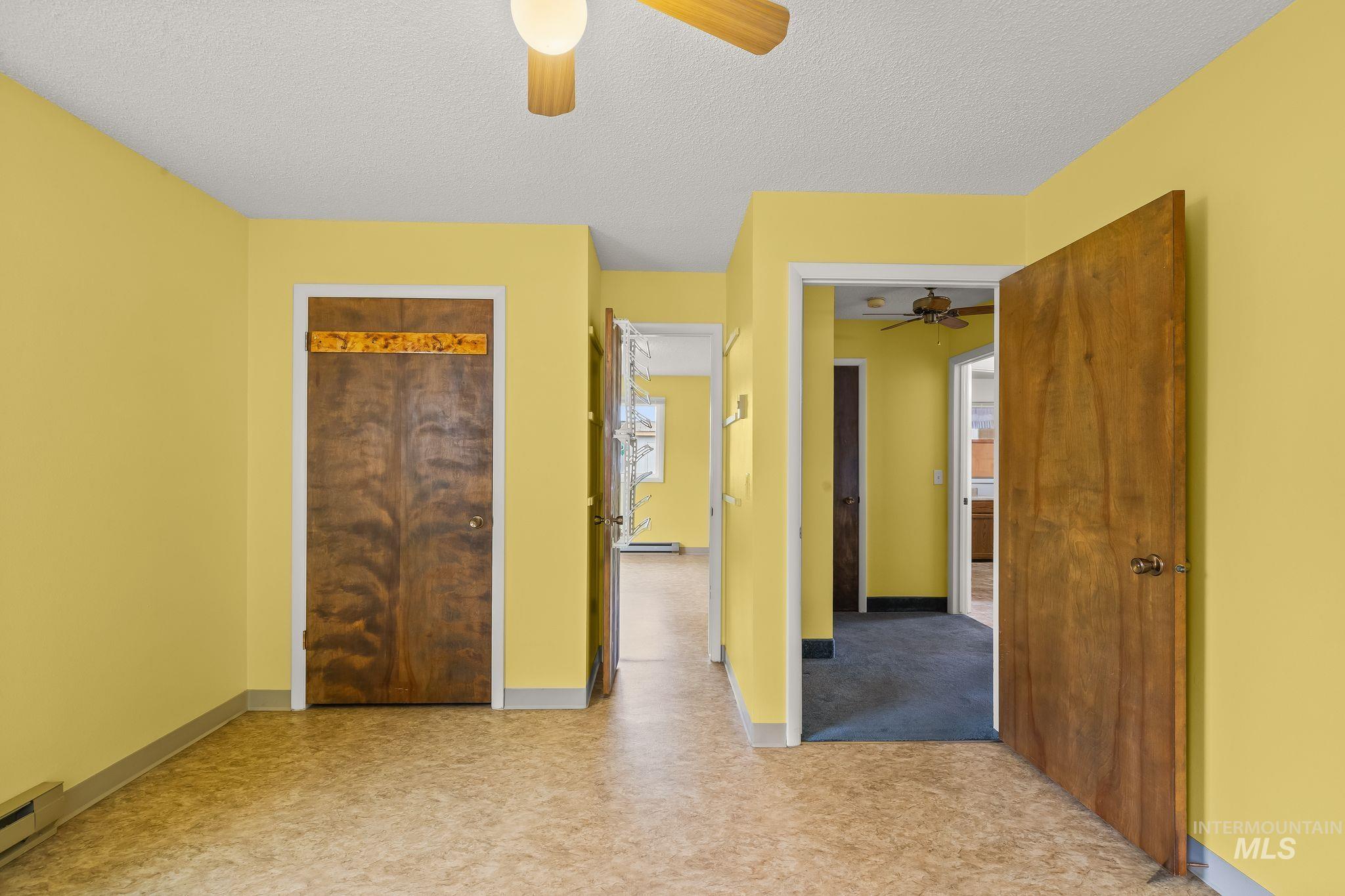 1721 3rd Street Lewiston, ID 83501 - Photo 40 of 45 Interior space with light yellow walls, wood-finish flooring, and a ceiling fan