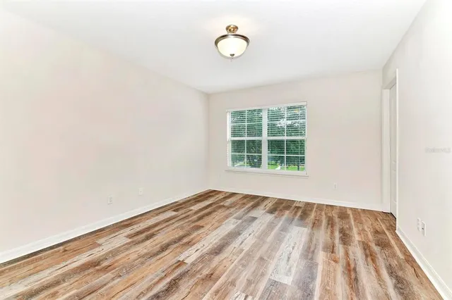 a view of a room with wooden floor and window