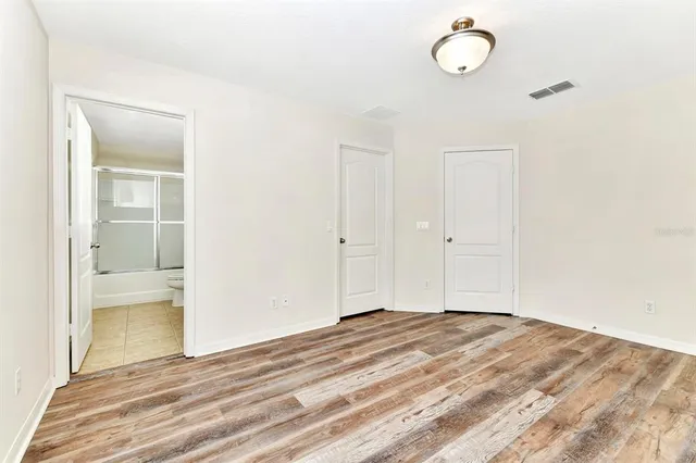 a view of a room with wooden floor and bathroom