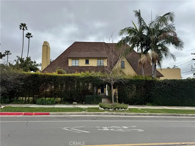 a view of a house in a yard with a bench