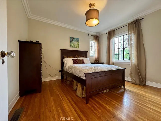 a bedroom with a large bed and a window