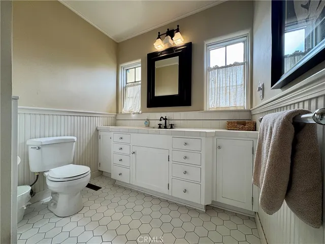 a large bathroom with a double vanity sink a mirror and a bathtub