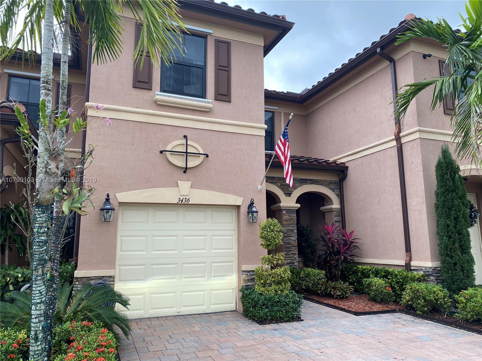 3436 West 90th Street, Unit 3436 Hialeah, FL 33018 - Photo 1 of 56 a front view of a house with a garage