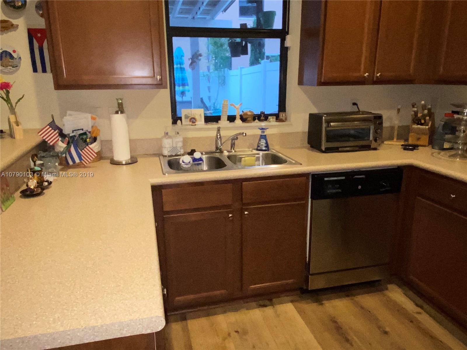 3436 West 90th Street, Unit 3436 Hialeah, FL 33018 - Photo 13 of 56 a kitchen with a sink and cabinets