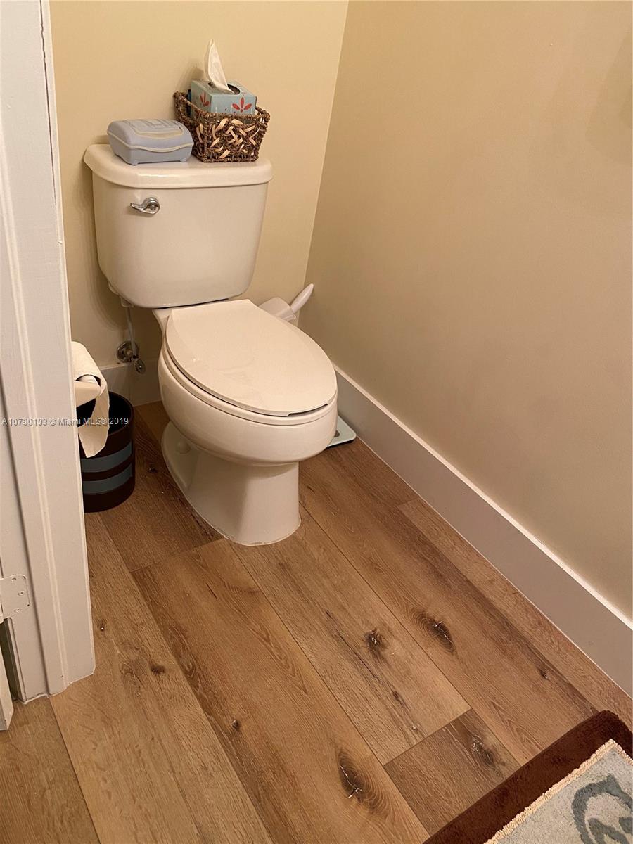 3436 West 90th Street, Unit 3436 Hialeah, FL 33018 - Photo 14 of 56 a white toilet sitting next to a white cabinet