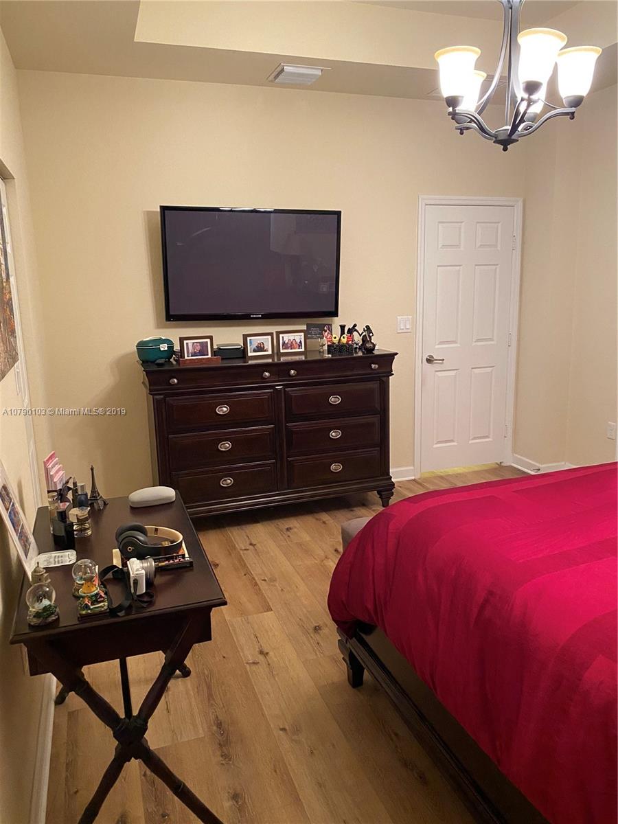 3436 West 90th Street, Unit 3436 Hialeah, FL 33018 - Photo 33 of 56 a bedroom with a bed and a table in it