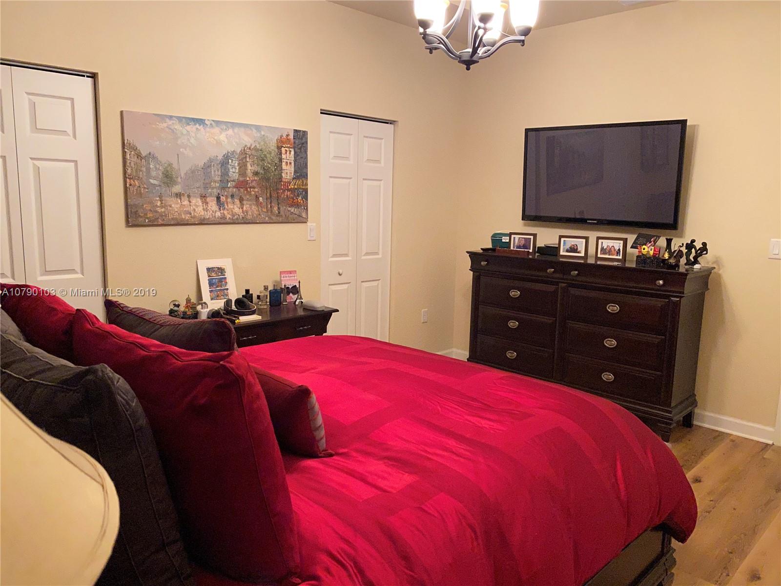 3436 West 90th Street, Unit 3436 Hialeah, FL 33018 - Photo 34 of 56 a bed room with a bed and a flat screen tv