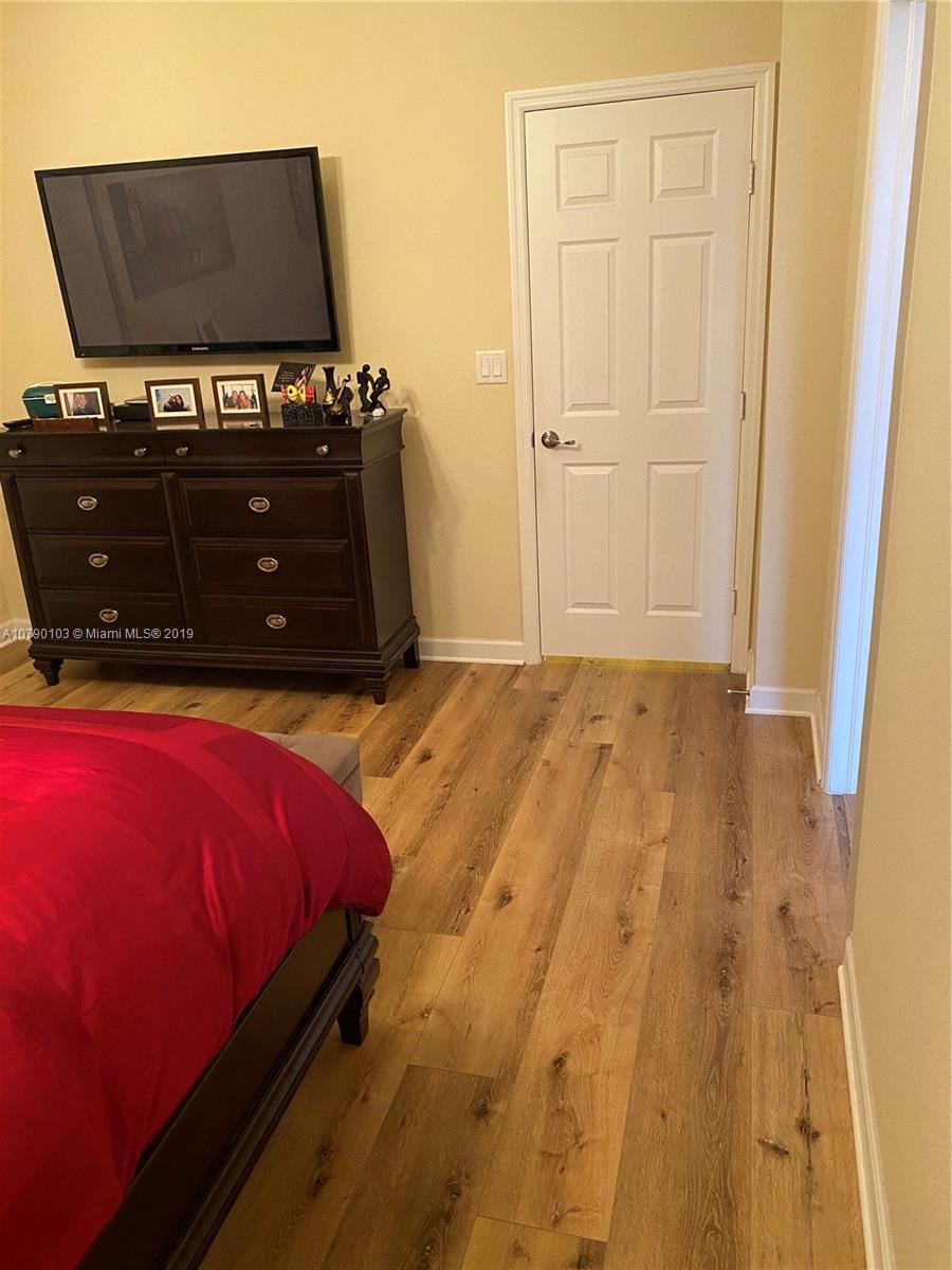 3436 West 90th Street, Unit 3436 Hialeah, FL 33018 - Photo 35 of 56 a bedroom with a bed and flat screen tv