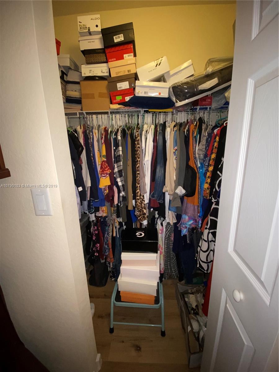 3436 West 90th Street, Unit 3436 Hialeah, FL 33018 - Photo 36 of 56 a view of walk in closet with clothes and shoes