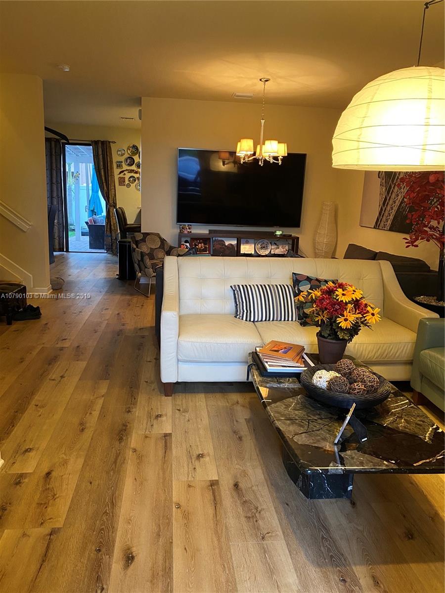 3436 West 90th Street, Unit 3436 Hialeah, FL 33018 - Photo 4 of 56 a living room with furniture and a flat screen tv