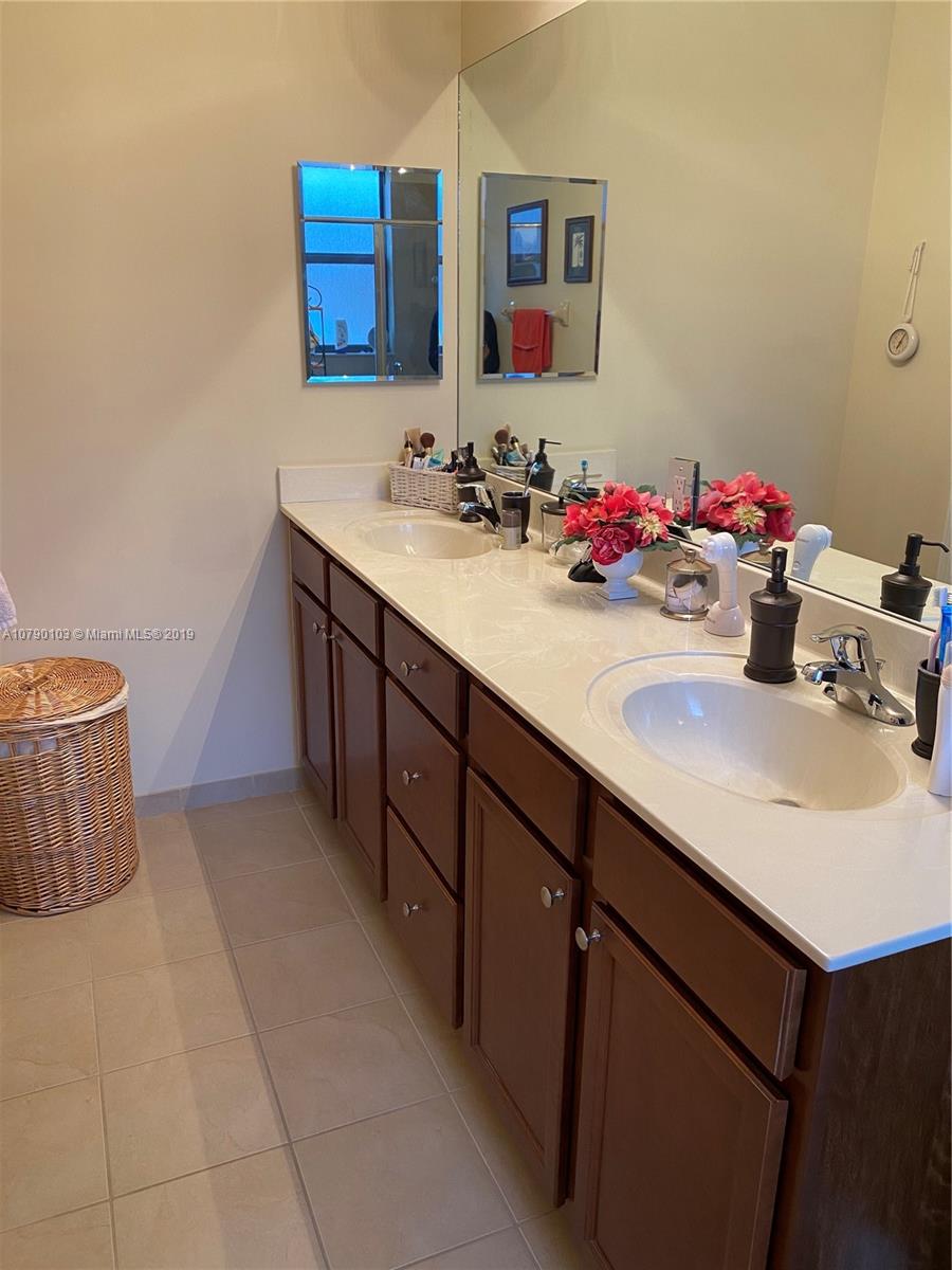 3436 West 90th Street, Unit 3436 Hialeah, FL 33018 - Photo 41 of 56 a bathroom with a sink and a mirror