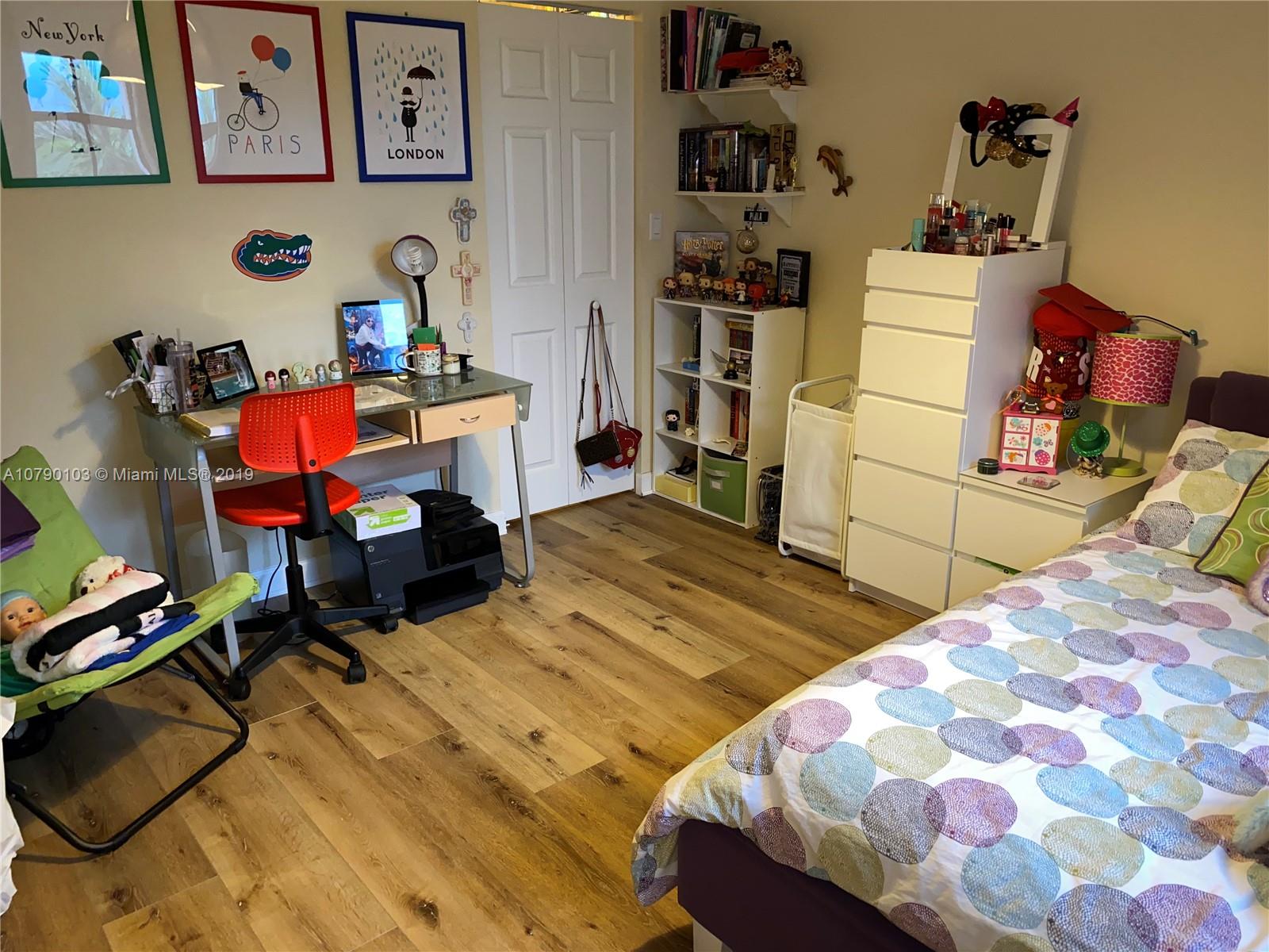 3436 West 90th Street, Unit 3436 Hialeah, FL 33018 - Photo 43 of 56 a bedroom with a bed and wooden floor