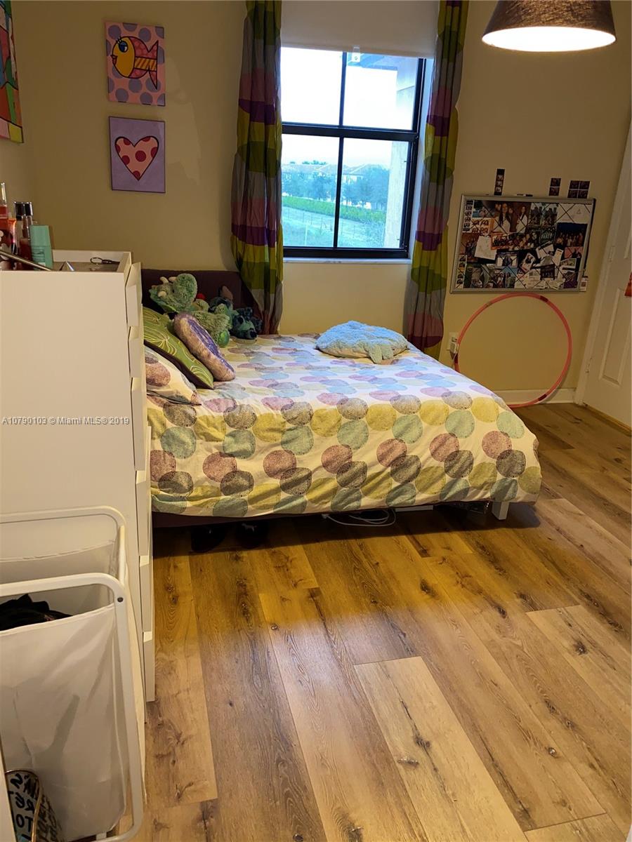 3436 West 90th Street, Unit 3436 Hialeah, FL 33018 - Photo 44 of 56 a bed sitting in a bedroom next to a window