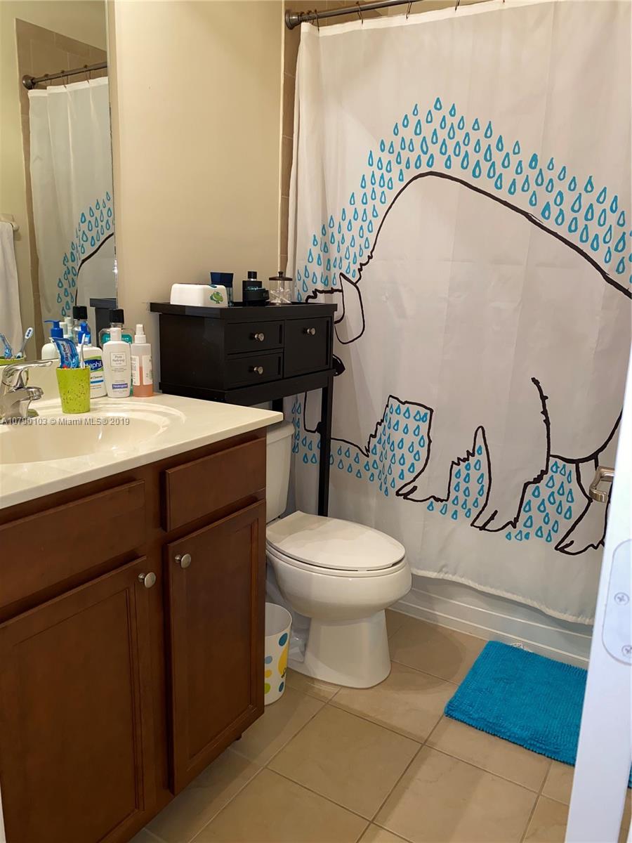 3436 West 90th Street, Unit 3436 Hialeah, FL 33018 - Photo 48 of 56 a bathroom with a sink a toilet and mirror