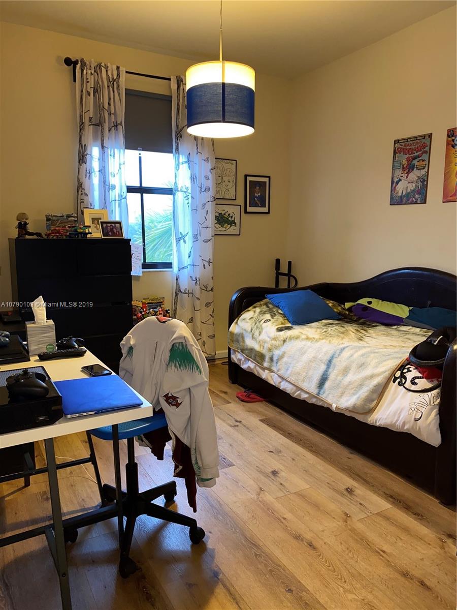 3436 West 90th Street, Unit 3436 Hialeah, FL 33018 - Photo 50 of 56 a bedroom with bed and a window