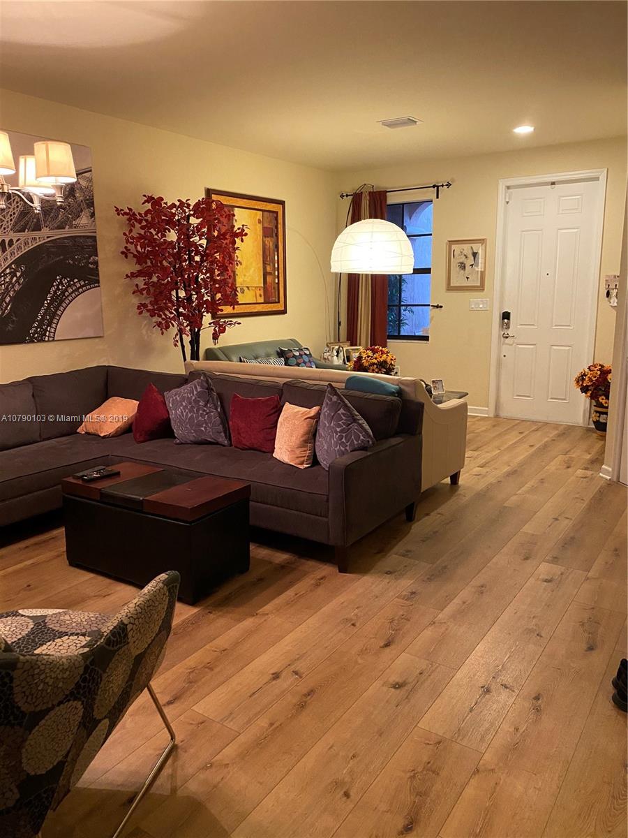 3436 West 90th Street, Unit 3436 Hialeah, FL 33018 - Photo 6 of 56 a living room with furniture and a lamp