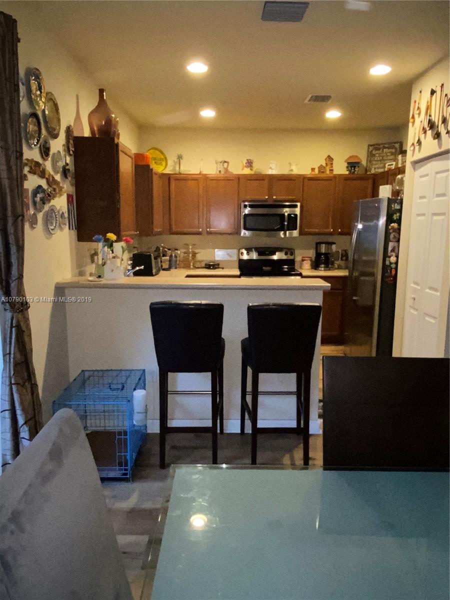 3436 West 90th Street, Unit 3436 Hialeah, FL 33018 - Photo 9 of 56 a kitchen with a sink cabinets and wooden floor