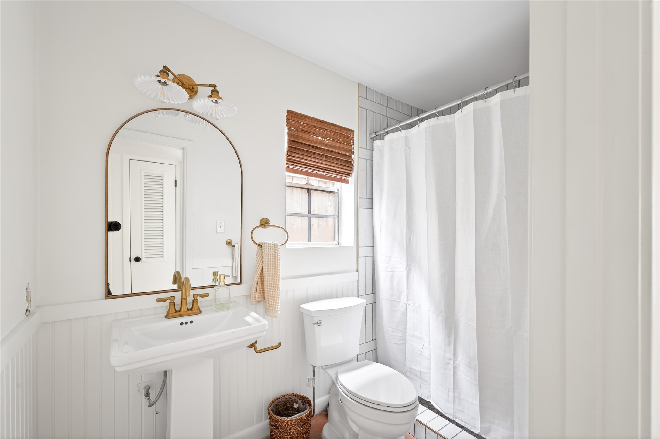 1700 Houston Street, Unit 102 Austin, TX 78756 - Photo 12 of 24 a bathroom with a sink a toilet and a mirror