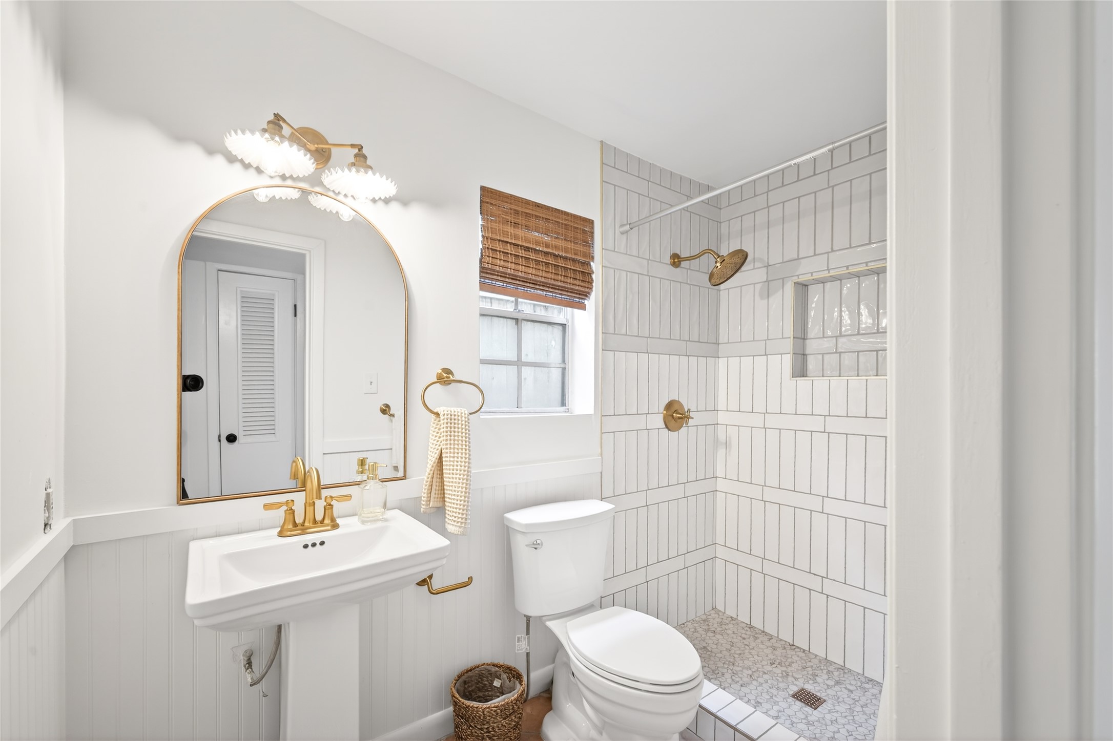 1700 Houston Street, Unit 102 Austin, TX 78756 - Photo 13 of 24 a bathroom with a sink a toilet a mirror and shower