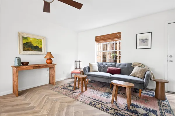 a living room with furniture a rug and a window