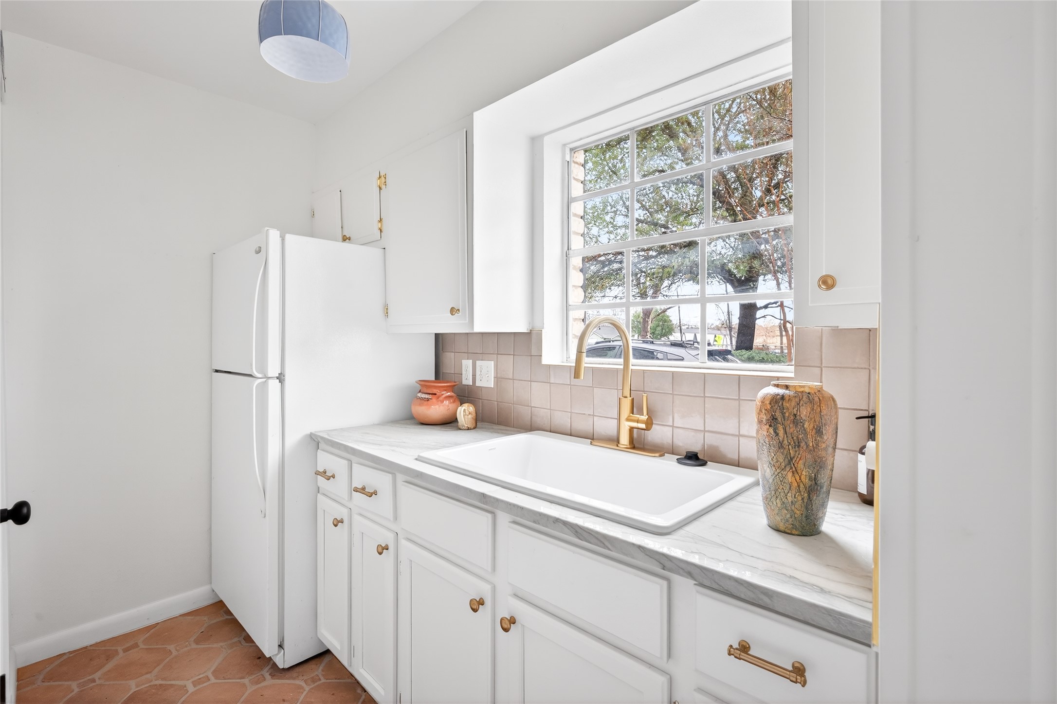 1700 Houston Street, Unit 102 Austin, TX 78756 - Photo 5 of 24 a kitchen with appliances cabinets and a sink