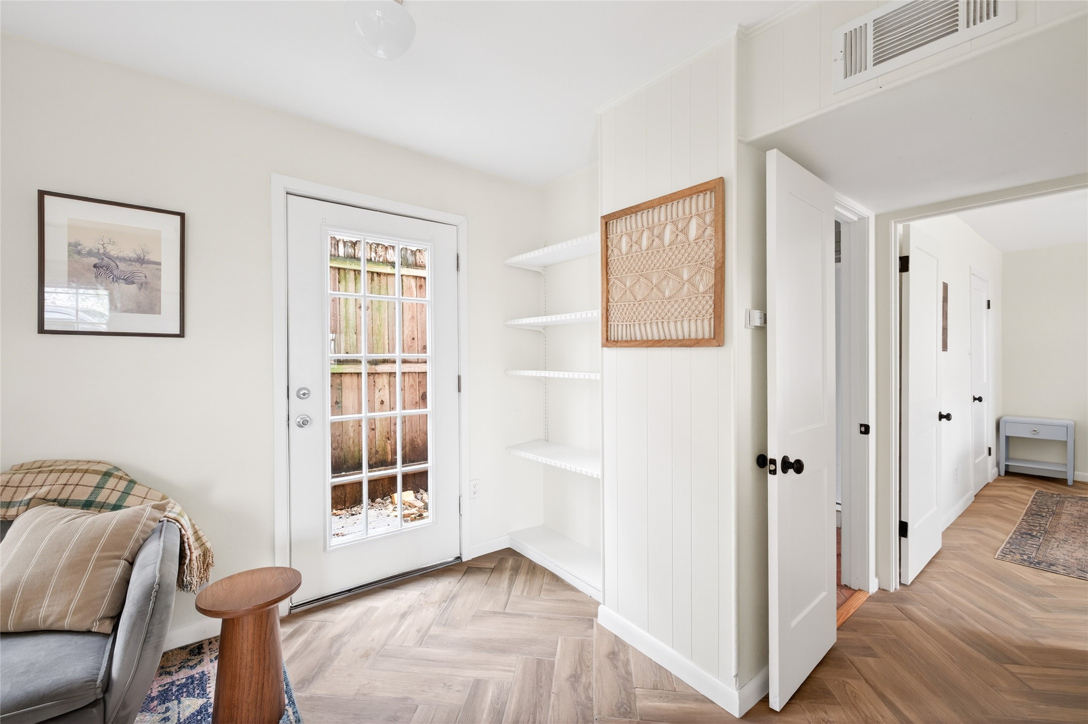 1700 Houston Street, Unit 102 Austin, TX 78756 - Photo 9 of 24 a view of a bedroom with wooden floor and windows