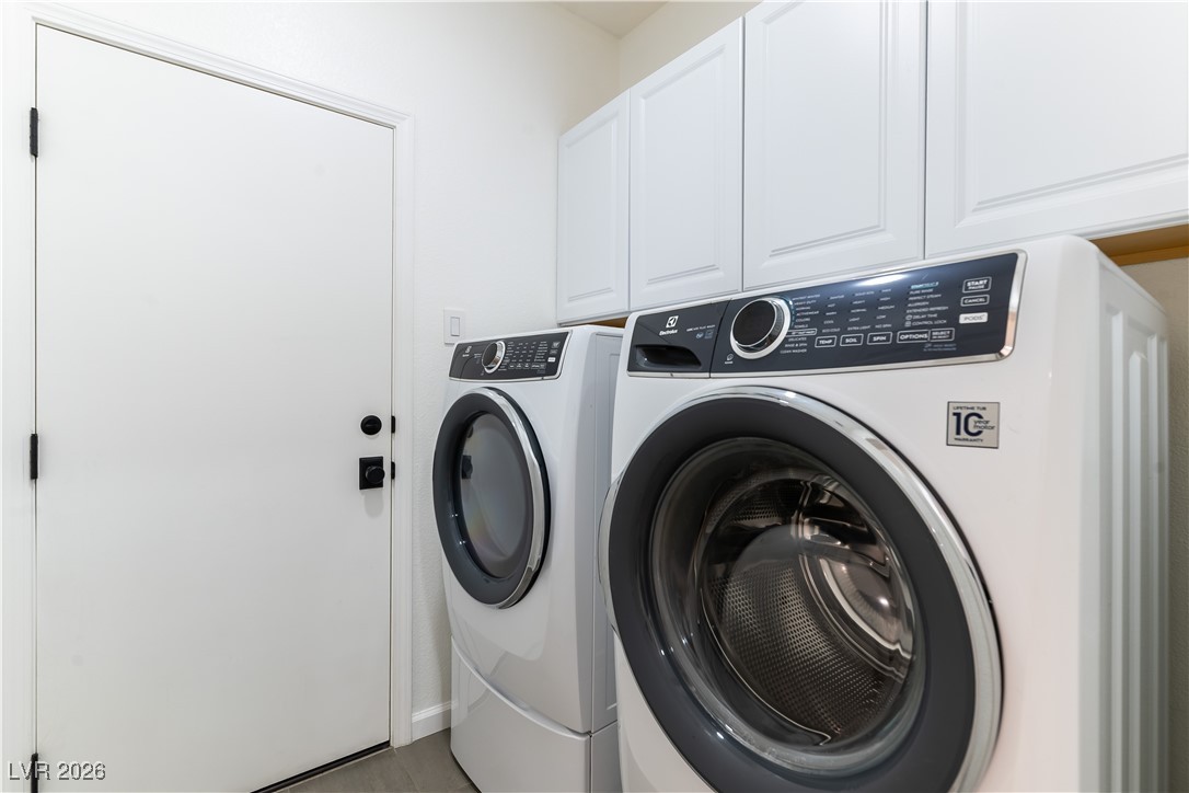 2344 Teton Ranch Avenue Henderson, NV 89052 - Photo 21 of 32 Laundry room featuring cabinet space and washer and clothes dryer