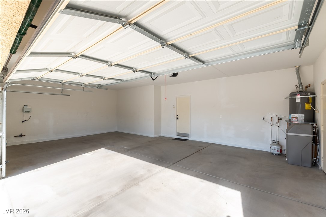 2344 Teton Ranch Avenue Henderson, NV 89052 - Photo 22 of 32 Expansive 3 car Garage featuring strapped water heater and baseboards
