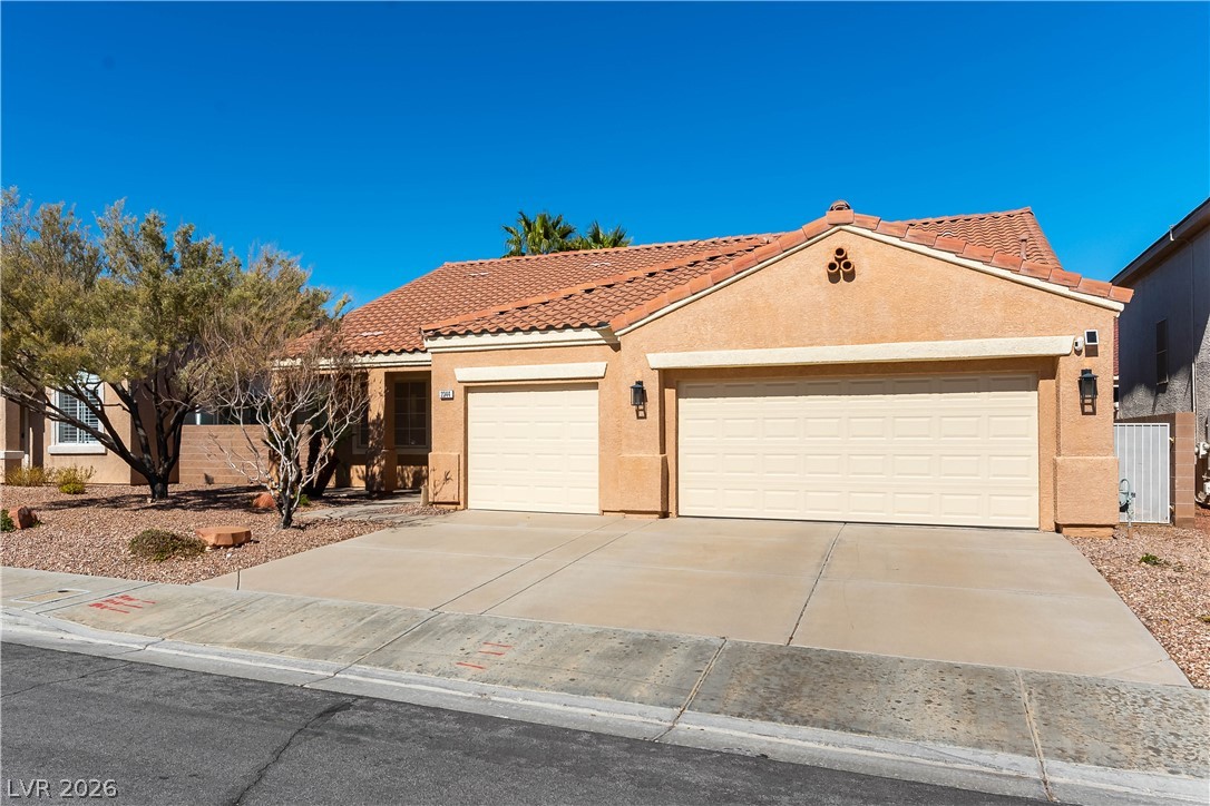 2344 Teton Ranch Avenue Henderson, NV 89052 - Photo 25 of 32 Mediterranean / spanish home featuring stucco siding, an attached garage, driveway, and a tile roof