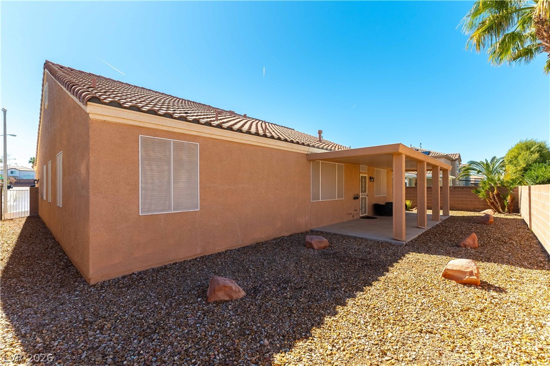 2344 Teton Ranch Avenue Henderson, NV 89052 - Photo 28 of 32 Rear view of house with a patio, a fenced backyard, stucco siding, and a tile roof