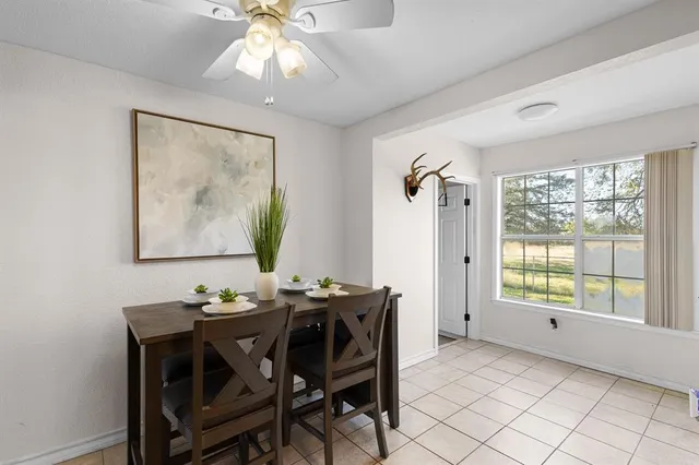 a dining room with furniture and window