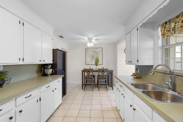 a kitchen with granite countertop a sink and cabinets