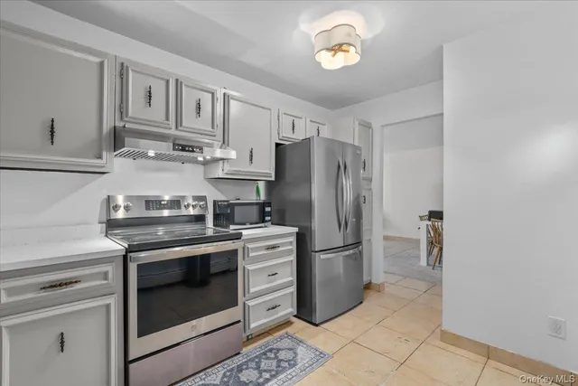 a kitchen with stainless steel appliances granite countertop a stove a refrigerator and a refrigerator