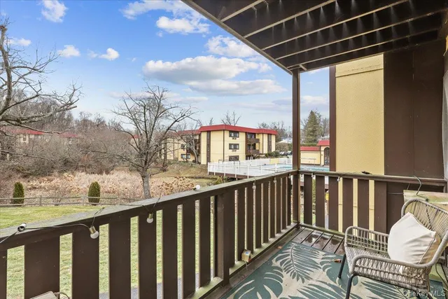 a view of balcony with furniture