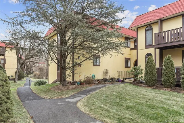 a view of staircase with white walls and a window