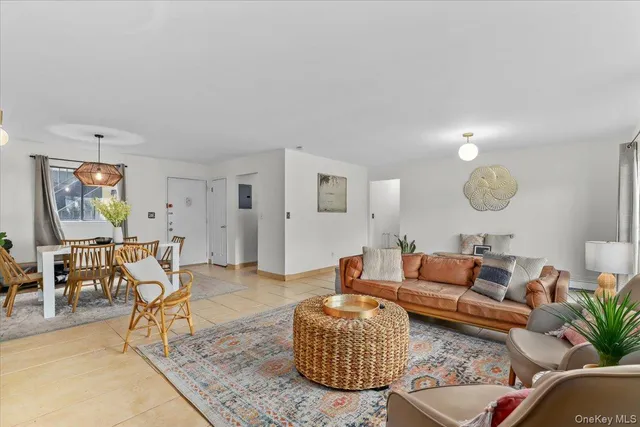 a living room with furniture a rug and a lamp