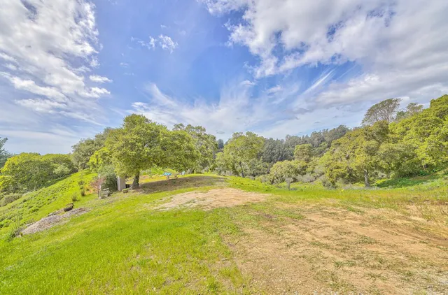a swimming pool with an outdoor space and seating
