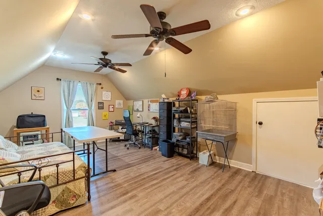 a view of a livingroom with furniture and a ceiling fan
