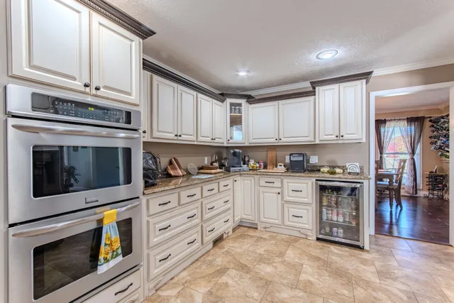 a kitchen with stainless steel appliances granite countertop a stove and cabinets
