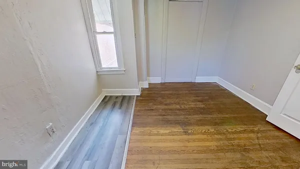 a view of room with wooden floor