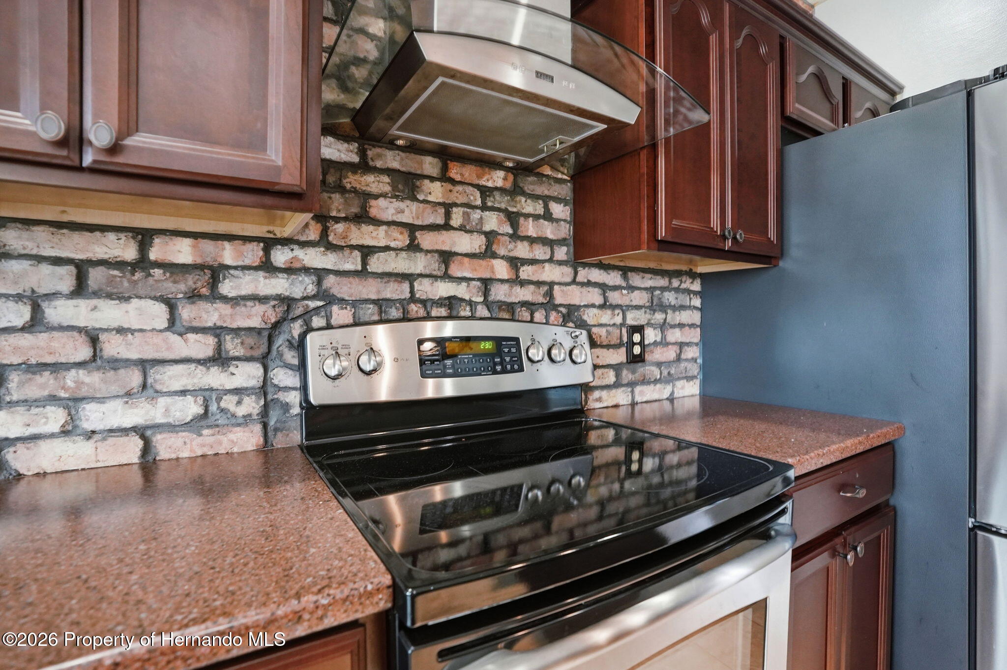 18131 Rivard Boulevard Brooksville, FL 34604 - Photo 13 of 66 a stove top oven sitting inside of a kitchen