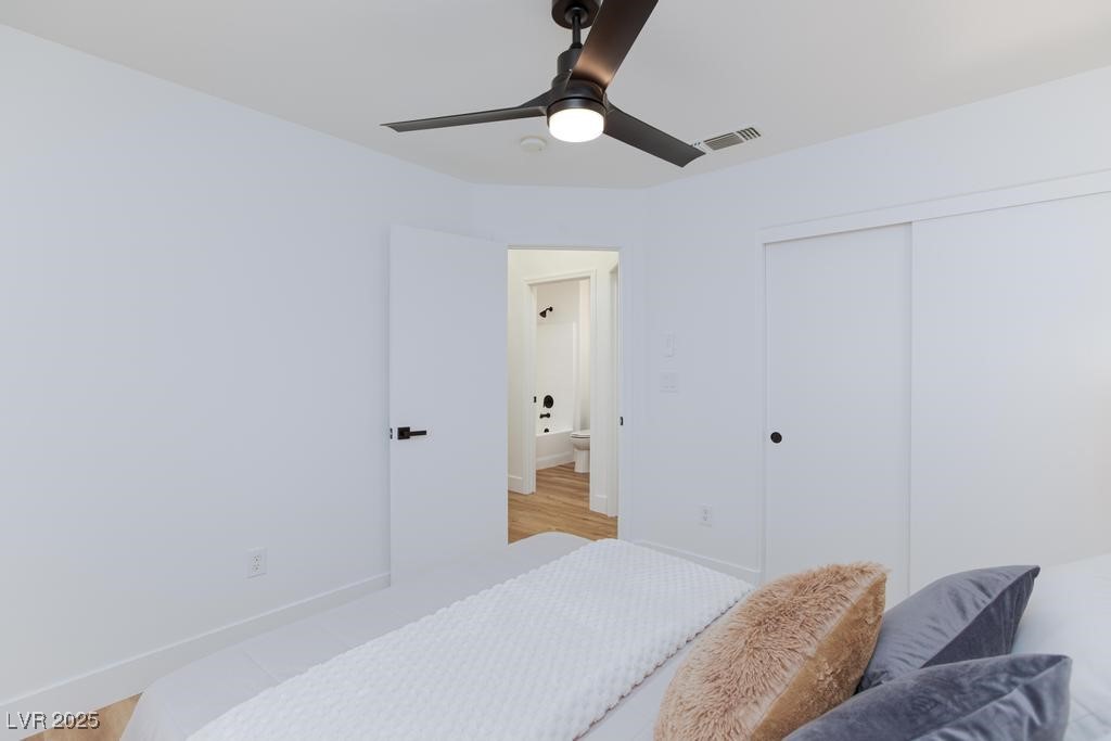 502 Edgefield Ridge Place Henderson, NV 89012 - Photo 24 of 38 Bedroom with a closet, baseboards, ceiling fan, and light wood-style flooring