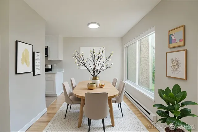 a view of a dining room with furniture and a potted plant