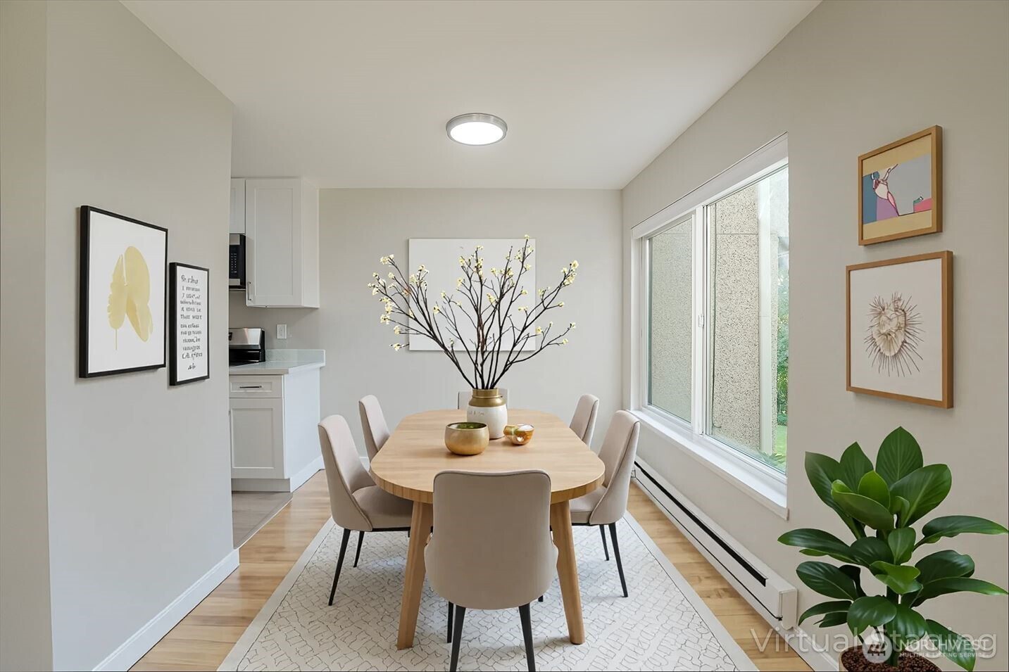 1100 South Atlantic Street, Unit 209 Seattle, WA 98134 - Photo 12 of 31 a view of a dining room with furniture and a potted plant
