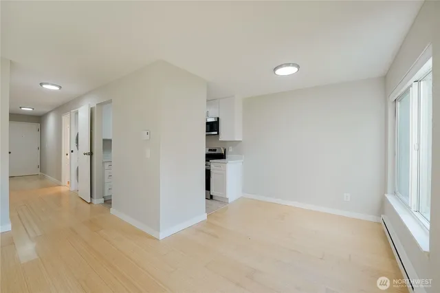 a view of a kitchen with a sink and a refrigerator