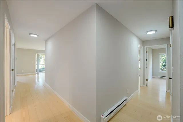 a view of a hallway with wooden floor